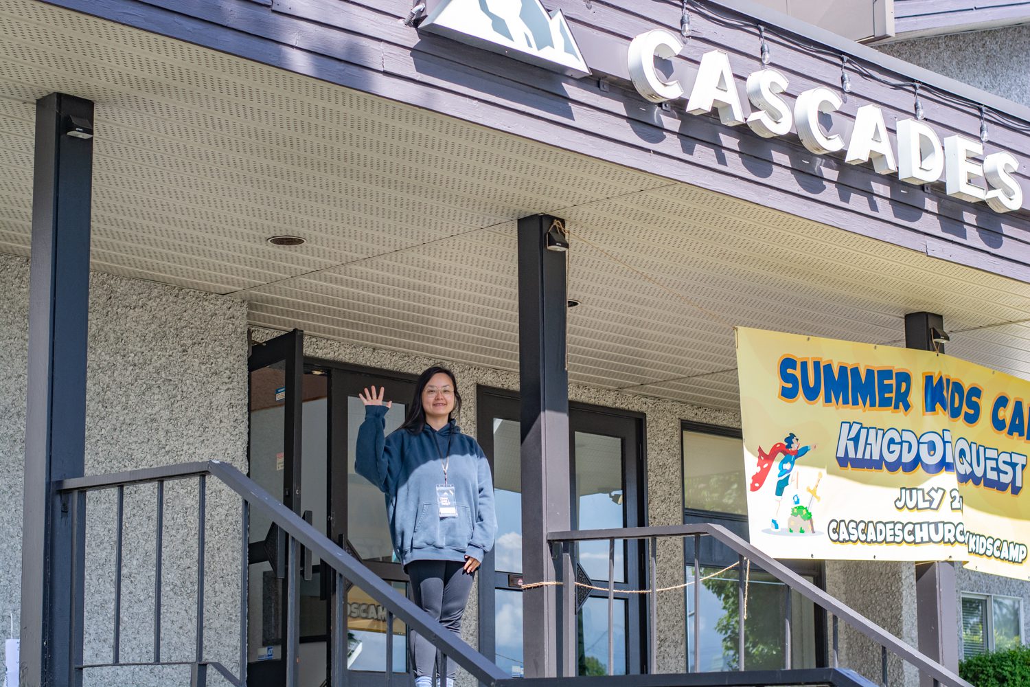 Greeter waving hello at Cascades front entrance